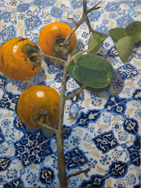persimmons on a blue tile