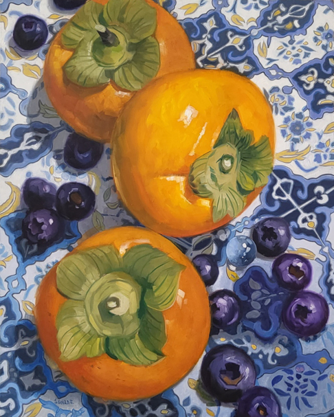 Persimmons on blue tile
